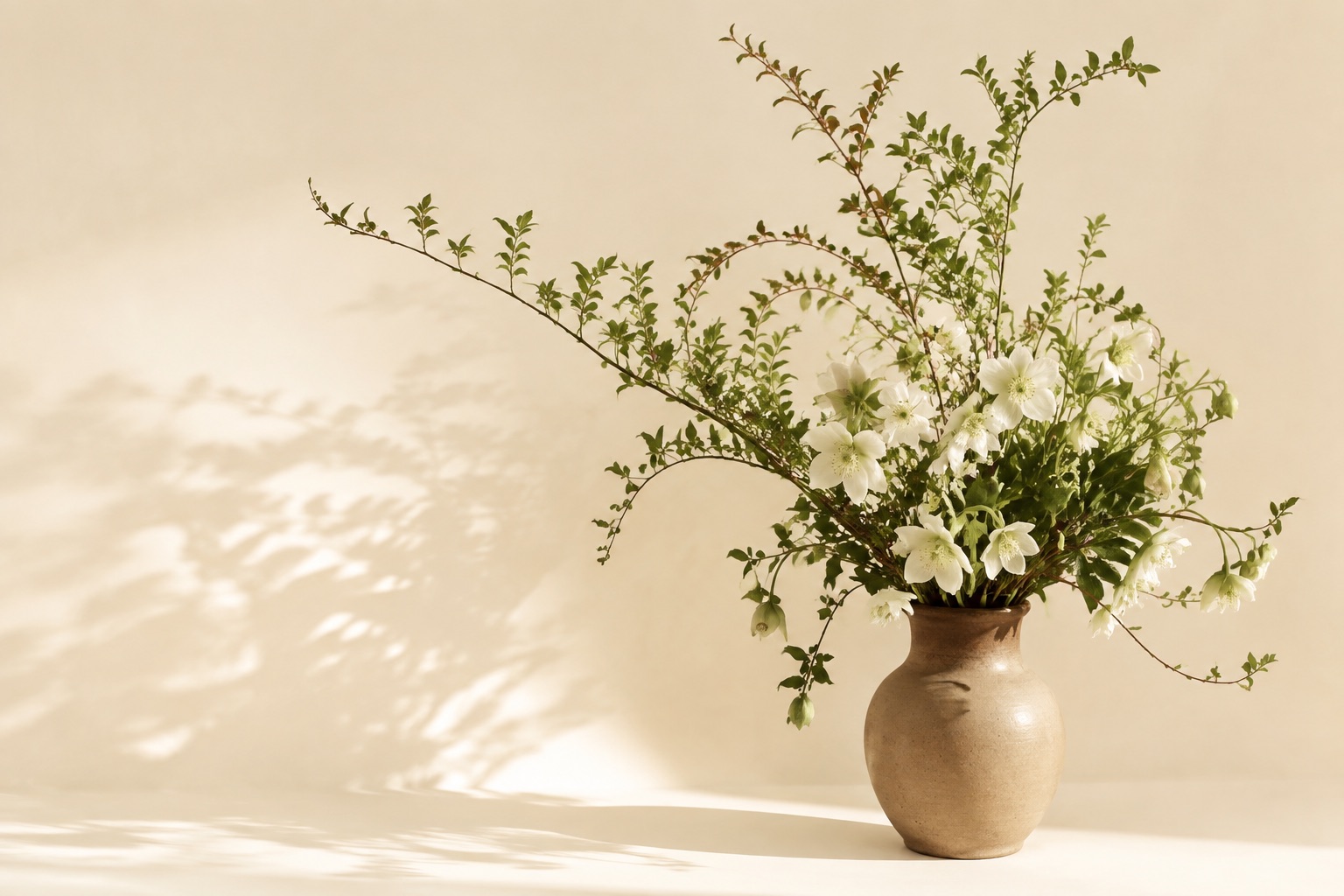 An illustrative arrangement of green branches and white flowers against warm vellum
